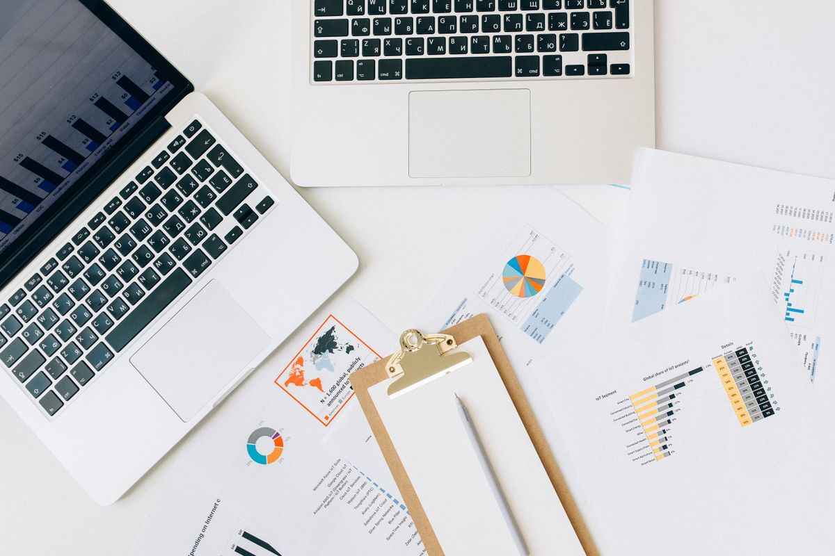 Laptop, charts, and reports arranged for business data analysis